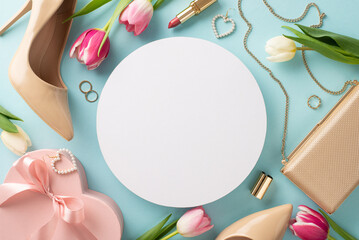 Mother's Day surprise concept. Chic and stylish top view of high-heels, handbag, gift box, tulip flowers, lipstick, makeup brushes, and earrings on a pastel blue background with blank circle