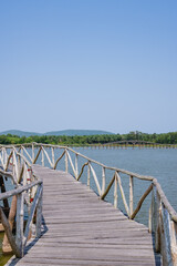 Fototapeta na wymiar A long wooden bridge extending into the reservoir