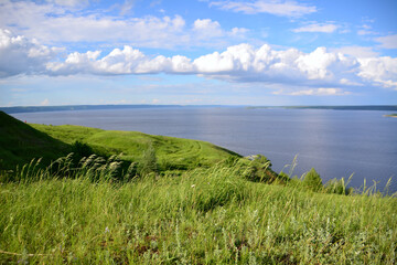 A view of the lake from the mountains with amazing clouds over horizon
