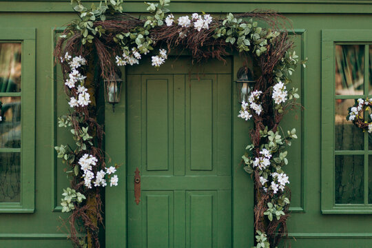 Facade of an attractive house painted green. green door of the house.
