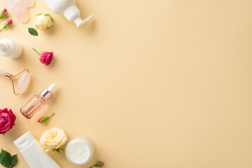 Obraz na płótnie Canvas Glamorous skincare concept. Top view of skincare cream bottle, serum, and jade face roller with fresh rose petals on a pastel beige background and an empty space for branding
