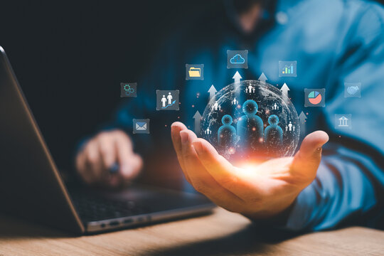 Customer network relationship management concept on virtual screens, Businessman use laptops and hold global structure customer network in hand, Data management and business work development