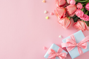Women's Day celebration idea. Flat lay composition of gift boxes bunch of pink roses and small hearts on isolated pastel pink background with copyspace