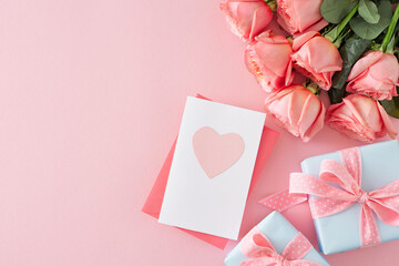 Mother Day gift concept. Top view photo of postcard with heart present boxes and bouquet of pink roses on isolated pastel pink background with empty space