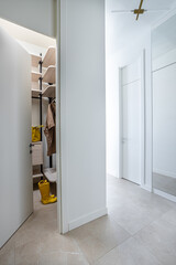 corridor with white walls with wardrobes and an open door to the dressing room