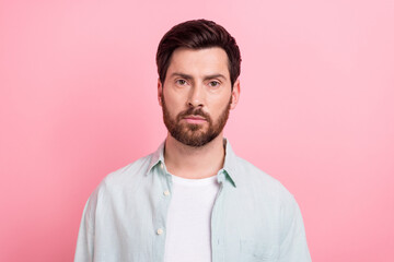 Photo portrait of attractive young man serious face indifferent calm dressed stylish blue clothes isolated on pink color background