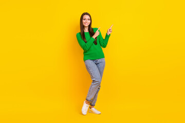 Fototapeta na wymiar Full body photo of gorgeous positive lady indicate fingers empty space isolated on yellow color background