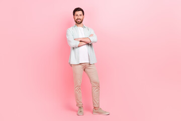 Fototapeta premium Full body photo of handsome young guy folded hands confident pose startup wear trendy blue clothes isolated on pink color background