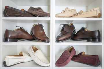 Men's shoes collection in white shelf. Men's leather loafers, moccasins.