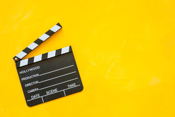 Top view of movie clapper board isolated on yellow - obrazy, fototapety, plakaty