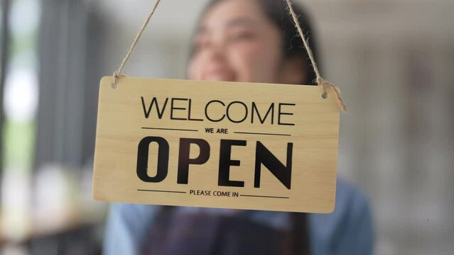 Coffee shop concept . Asian girls are opening a shop accepting customers