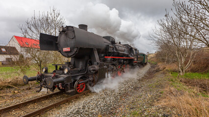 Obraz premium Historic steam train pulling several carriages