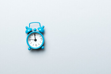 Alarm clock isolated on colored background with copy space top view