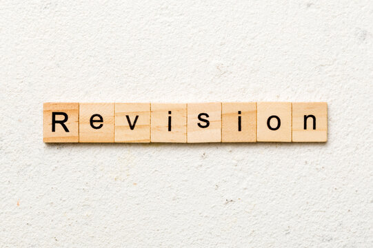 revision word written on wood block. revision text on table, concept