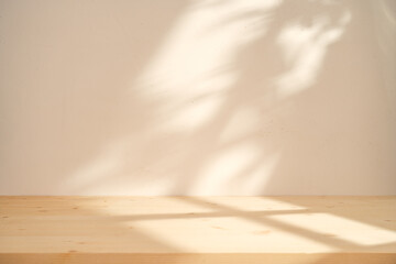 Empty table and window shadow on the plaster wall and light reflections. Mock up for presentation,...
