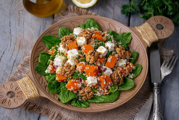 Squash, feta and bulgur salad. Tabbouleh style salad with roasted butternut squash or pumpkin,...