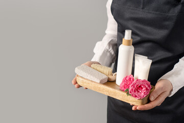 Tray with spa supplies in woman's hands, copy space