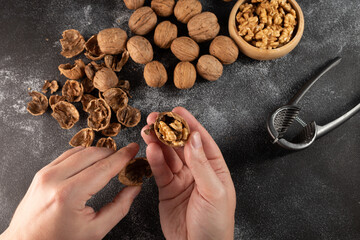close up of a person holding walnuts