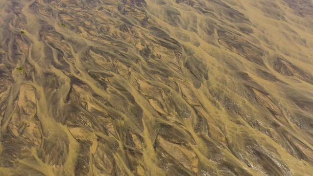 Aerial view of Low flowing river bed. Reduction of river waters in summer. Drought onset theme. Bucao river. Luzon, Philippines.