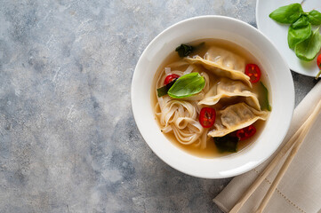 Miso soup with dumplings and rice noodles, top view. Copy space.