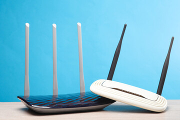 Two wi-fi routers on the table, blue background