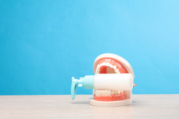 Jaw with a bottle of cream on the table, blue background
