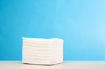 Stack of napkins on the table, blue background