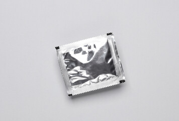 Foil pack with packaged seasoning for cooking on gray background