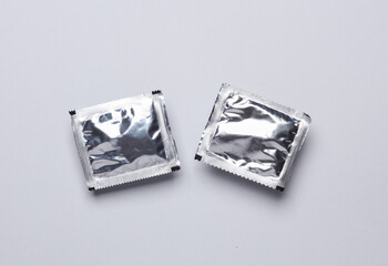 Foil packs with packaged seasoning for cooking on a gray background