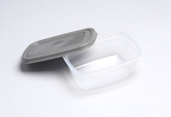 Fototapeta na wymiar Plastic container for storing food on a gray background