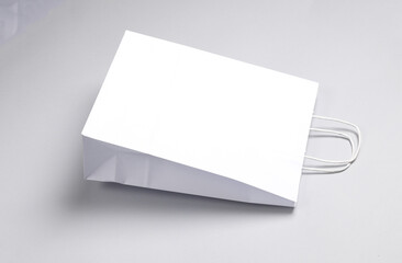 Two paper white shopping bag on gray background. Template for design