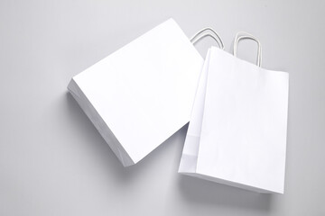 Two paper white shopping bags on gray background. Template for design