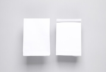 White food packs on gray background. Template for design