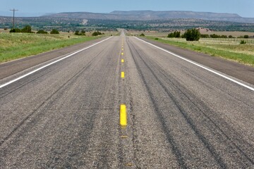 The open road of Route 66 with mountains in the diastance close to Santa Fe, NM, USA. 