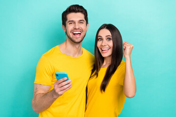 Photo of overjoyed couple best friends students celebrate read phone write message wireless fast...