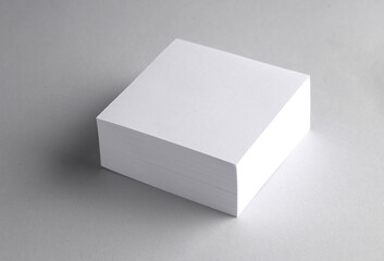 Stack of white blank square memo papers on gray background