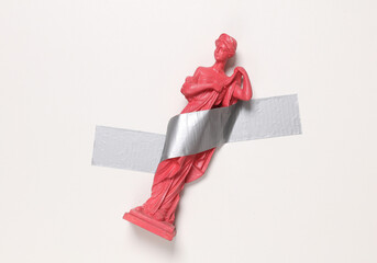 Antique statue of venus fixed with adhesive tape on white background. Conceptual pop, contemporary...