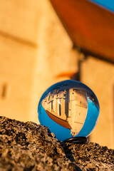 Crystal ball landscape shot with a church at Burgkirchen, Bavaria, Germany
