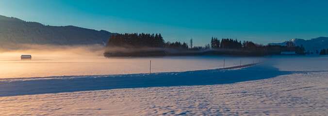 Foggy winter sunrise near Obersoechering, Weilheim-Schongau, Bavaria, Germany