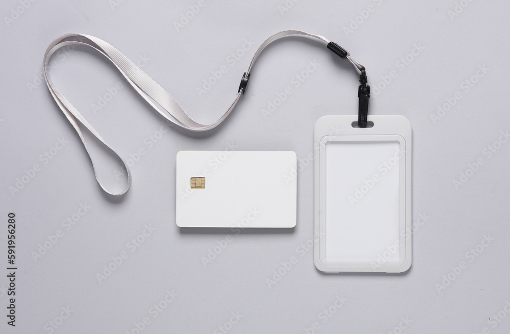 Wall mural Mockup of white blank bank card with chip and id card with rope on gray background. Template for design