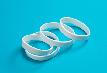 White silicone bracelets on a blue background