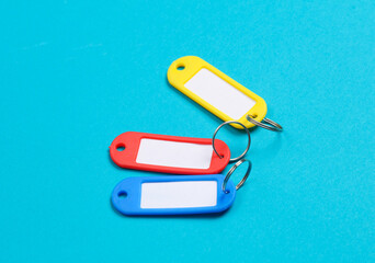 Plastic key tags on blue background