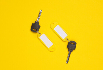 Plastic tags with keys on yellow background