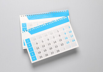 Desktop paper calendar organizer sheets on gray background. Planning, business, travel concept