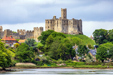 View over the river Coquet to the medieval Warkworth Castle and the village of Warkworth in Northumberland, England. - obrazy, fototapety, plakaty