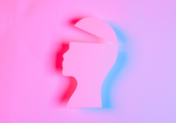 Paper cut open human head silhouette in red blue neon light