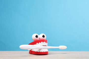 Joke jaw with a toothbrush on a blue background. Dental care