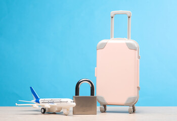Passenger plane model, lock and luggage on. Air travel ban