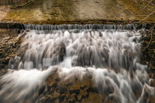 Small weir on Belca creek near bridge in Bohinjska Bistrica in Slovenia