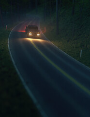 Pickup truck with illuminated headlights drives on a road in a misty forest during twilight. Generative AI.